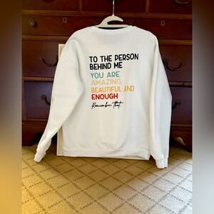 White long sleeved crewneck sweatshirt w motivational text on back XL NWOT
